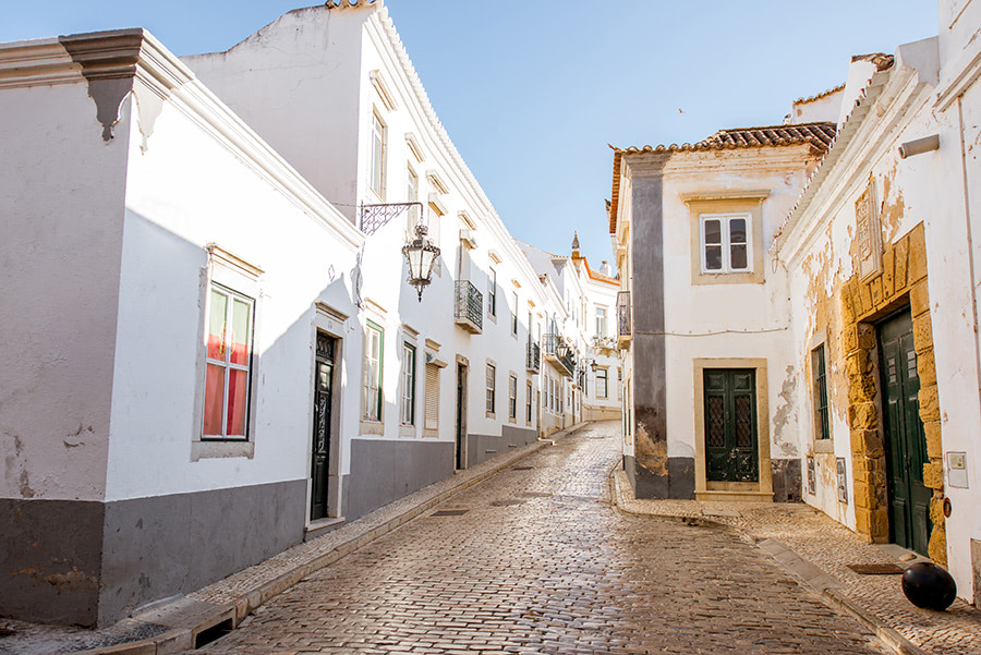 A picturesque street view in Faro, Portugal, a city with high Quick Home Sales.