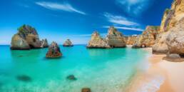 Climate in Portugal: Discover Mediterranean Warmth 29 A beautiful sandy beach in Portugal under the clear blue sky, highlighting the delightful climate in Portugal