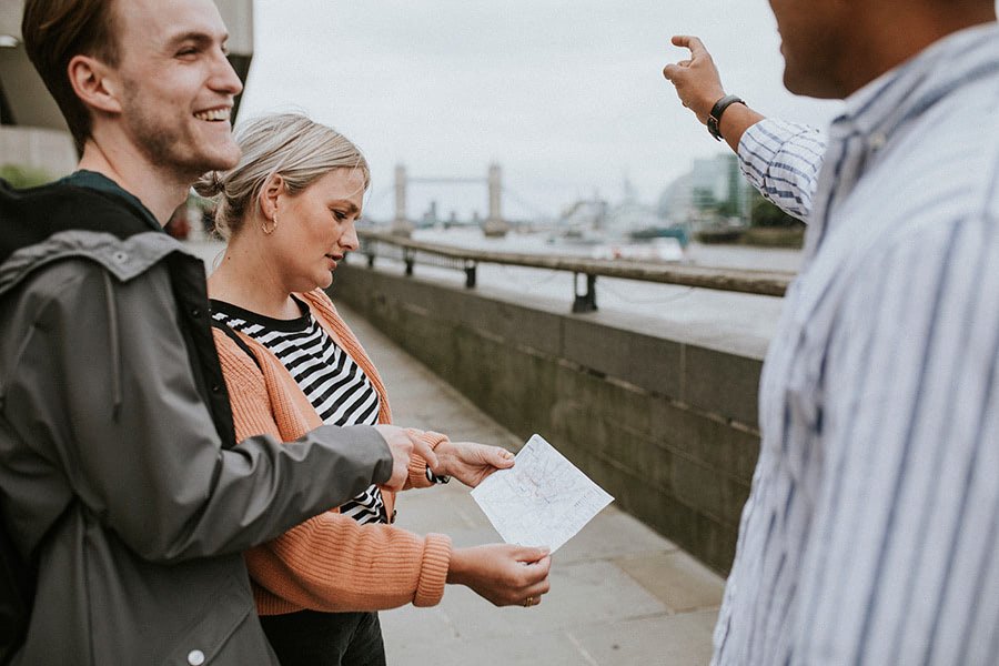 English-speaking tourists asking directions from a Portuguese local