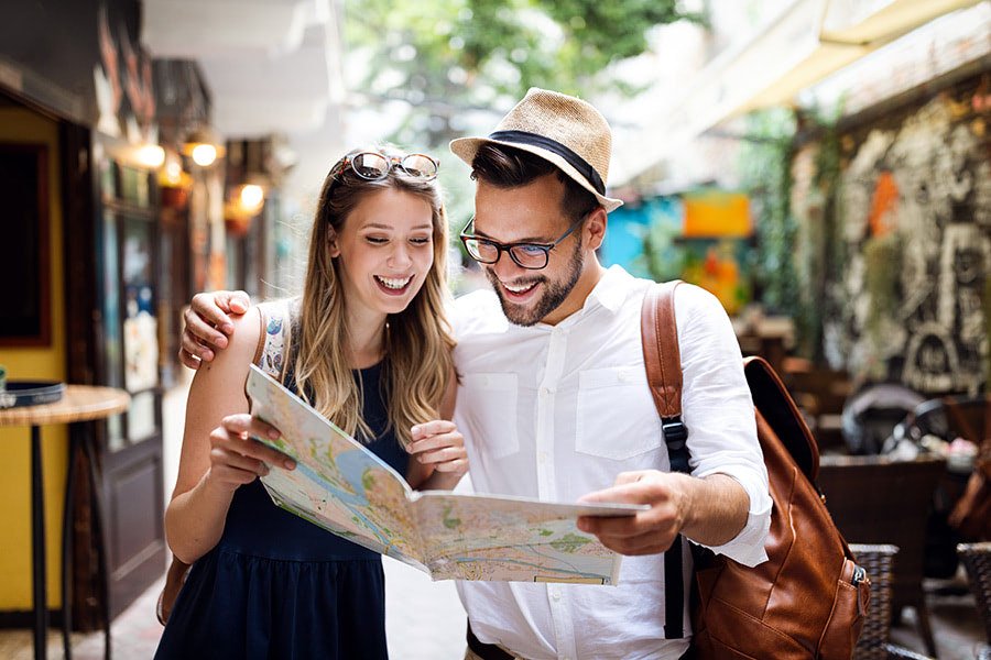 Tourists engaging in lively discussions in Portugal, reflecting the widespread usage of English language in the country.