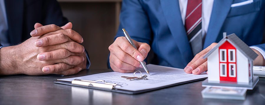 Business professionals signing a commercial real estate contract.