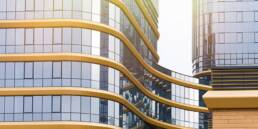 Commercial Real Estate in Portugal Grows 13% in 2023’s First Half 9 Office building exterior with commercial real estate signboards.