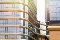 Commercial Real Estate in Portugal Grows 13% in 2023’s First Half 5 Office building exterior with commercial real estate signboards.