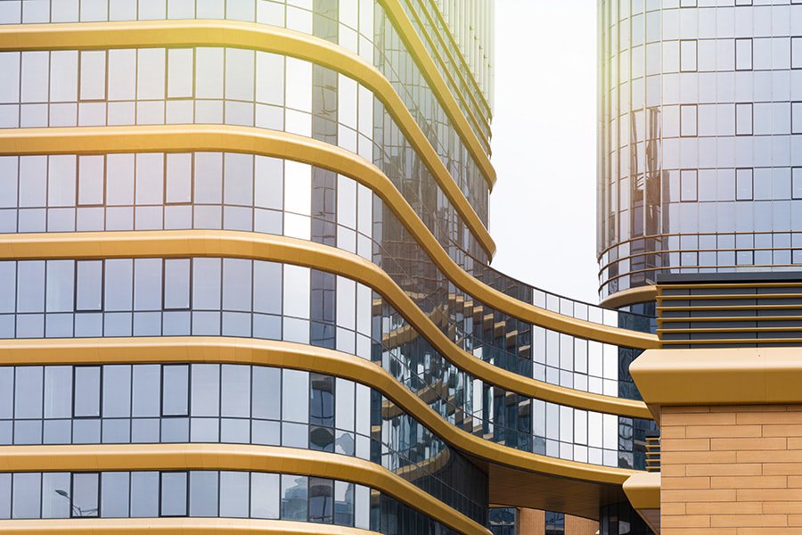 Office building exterior with commercial real estate signboards.