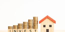 Portugal's Housing Prices in 2023: A Detailed District Breakdown & Insights 8 House model with coins and dice labeled 'Invest'